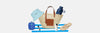 Wicker beach bag with sunglasses and sandals on a white sandy beach