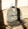 Isabel Marant blazer on a clothes hanger in a dry cleaning bag