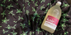 Bottle of Kair Wool, Silk and Delicates Wash lying on top of KITRI black and green Persephone star print dress