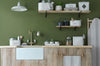 Laundry room with sink, storage tins, towels, shelves, ironing board, green wall