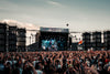 Festival-goers holding hands at an outdoor summer concert