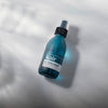 Kair Signature Finishing Spray - Wild Juniper & Bergamot against a white marble backdrop