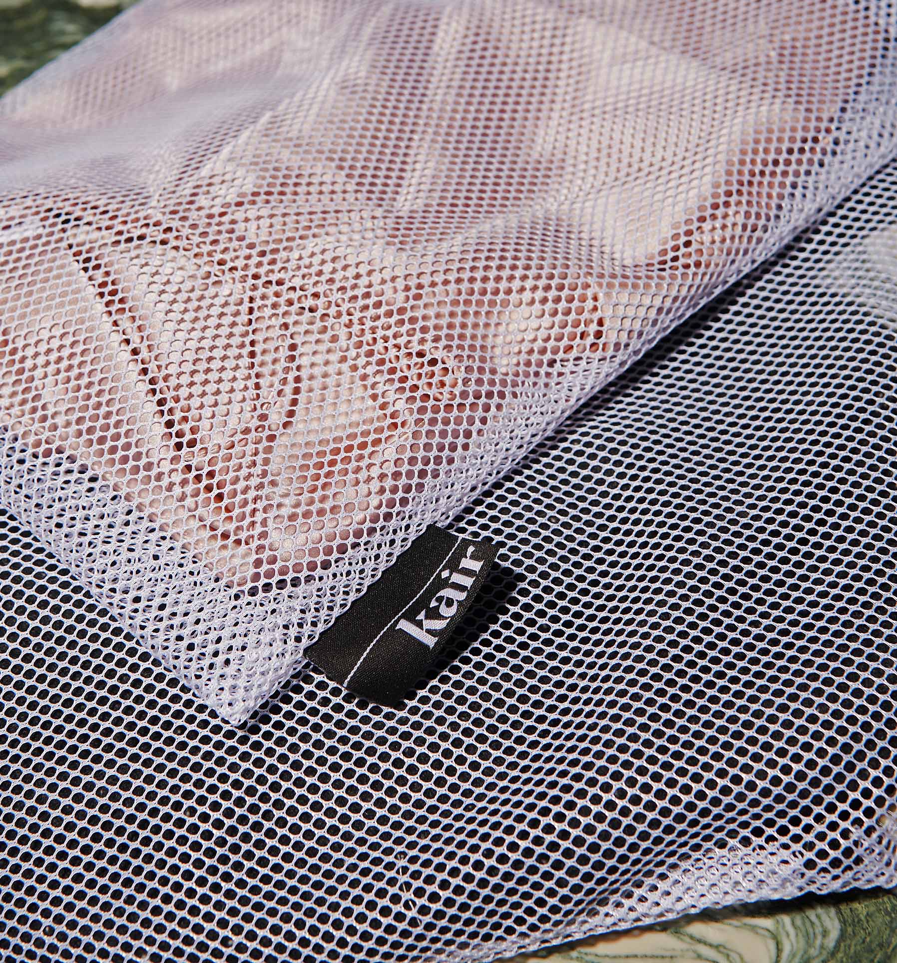 Kair mesh laundry bag containing a pink silk garment