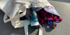 Holiday suitcase: swimsuit, suncream, vintage camera, travel map, sunglasses, hat