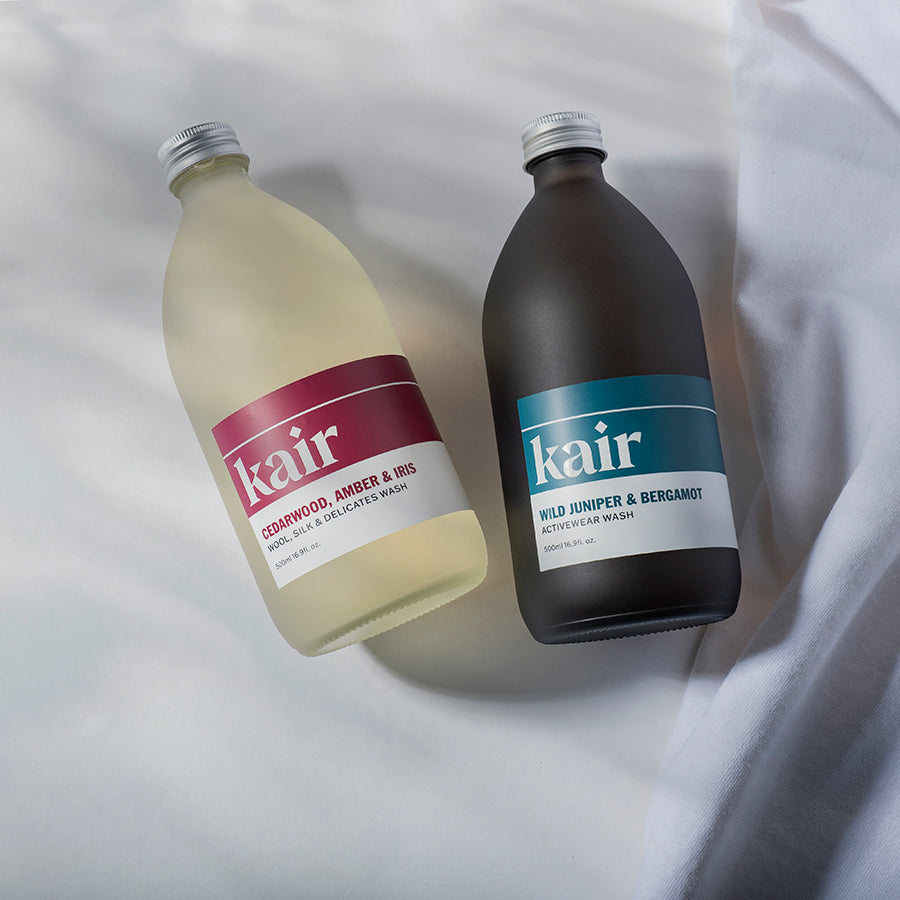 Bottles of Kair Specialist Bundle on white sheet - Wool, Silk and Delicates Wash next to Activewear Wash 